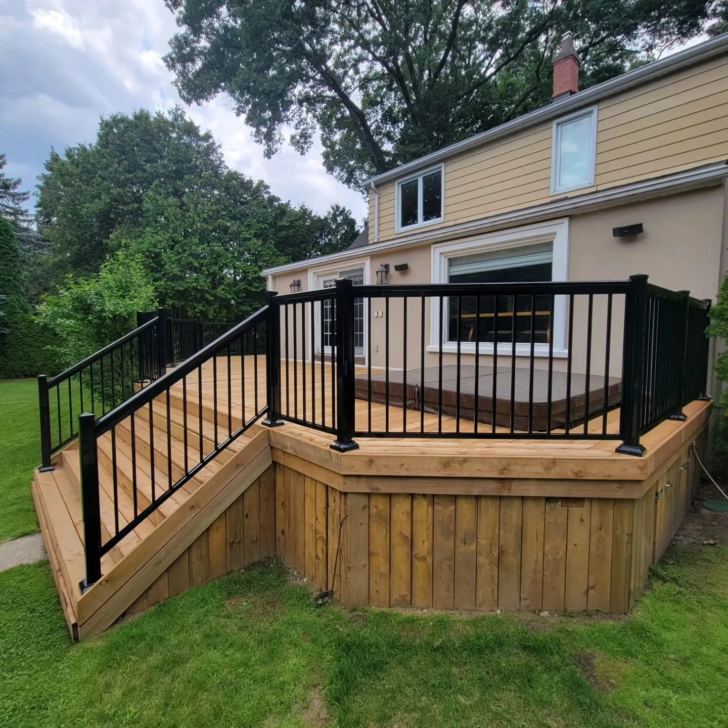 Newly built wooden deck with black aluminum railings