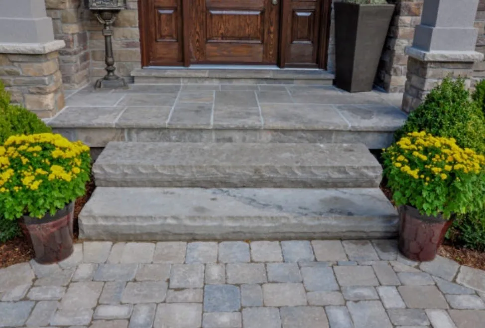 Front entryway with natural stone steps and interlocking paver landing